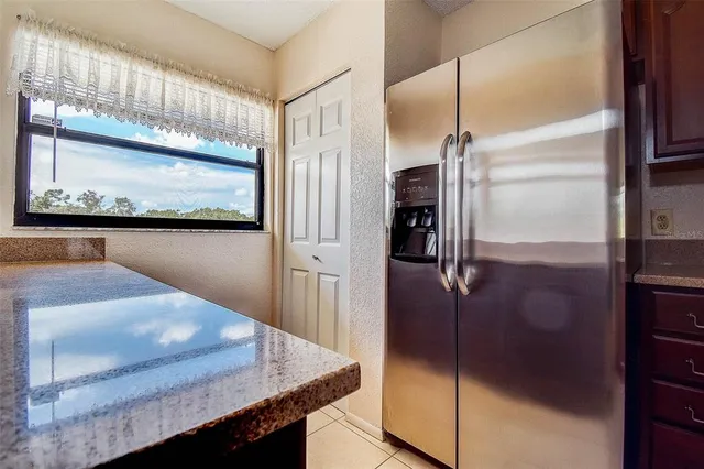 a kitchen with kitchen island a counter top and refrigerator