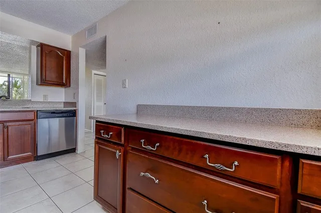 a kitchen with stainless steel appliances granite countertop a stove microwave and sink