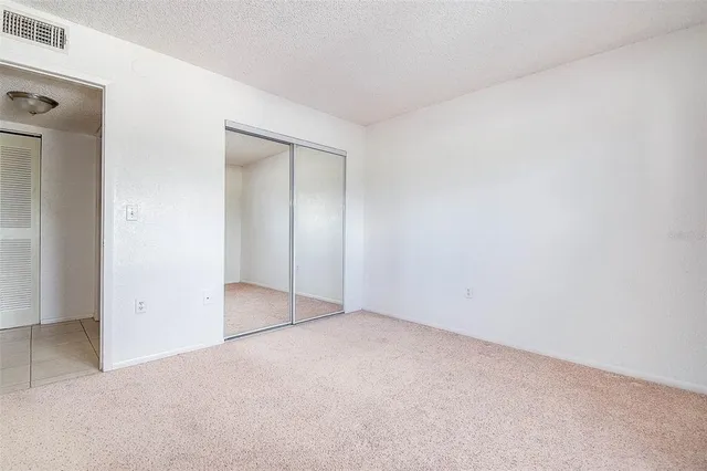 a view of a hallway with wooden shelves