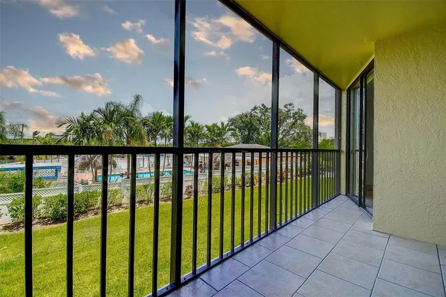 a view of a patio with a table and chairs under an umbrella