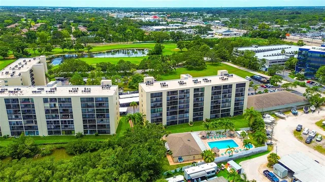 an aerial view of a city with lots of residential buildings ocean and mountain view