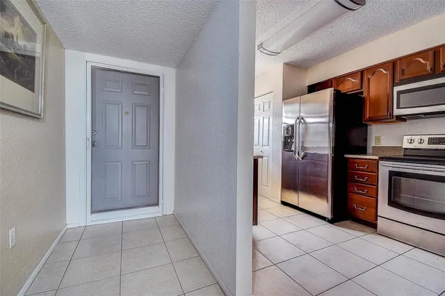 a kitchen with stainless steel appliances a stove sink and microwave