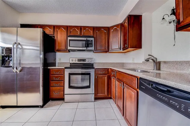 a kitchen with a refrigerator and a sink