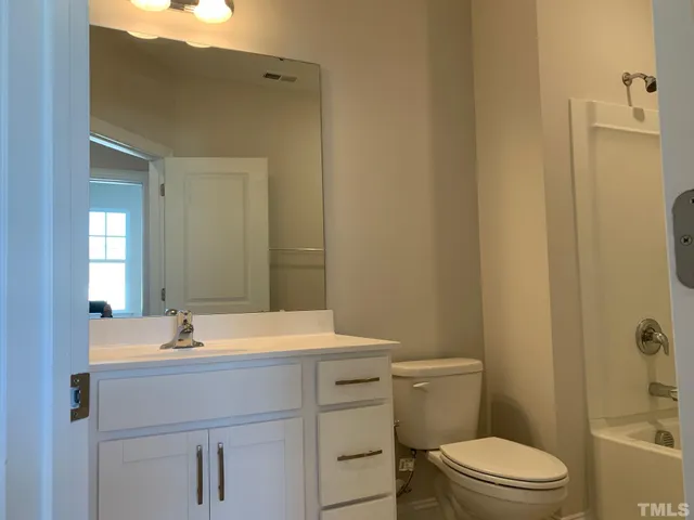 a bathroom with a sink toilet and vanity