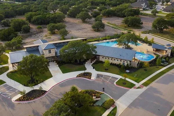 an aerial view of a house with garden space and street view