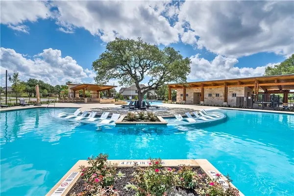 a view of swimming pool with outdoor seating and garden