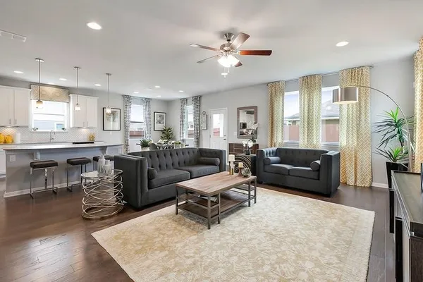 a living room with furniture and a chandelier