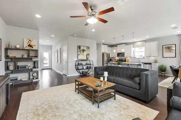 a living room with furniture and kitchen view