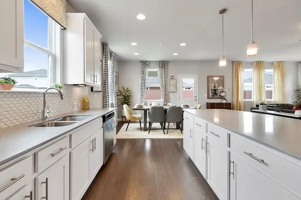 a large kitchen with stainless steel appliances a lot of counter space and a sink