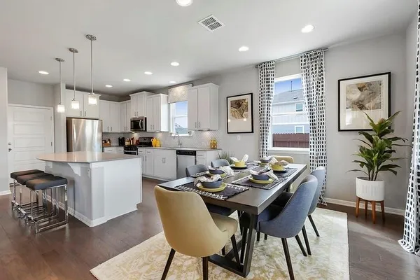 a dining room with stainless steel appliances kitchen island granite countertop furniture and a kitchen view