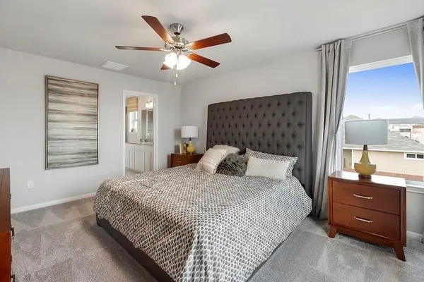 a bedroom with a bed and a chandelier