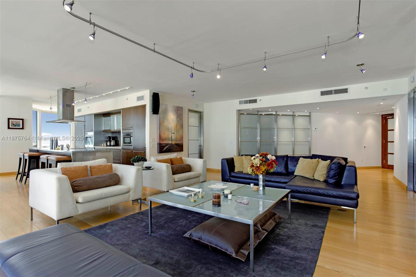 a living room with furniture a rug and a table