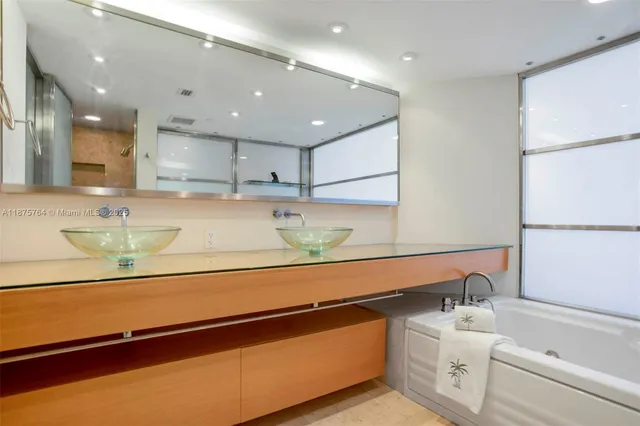 a bathroom with a sink a mirror and shower
