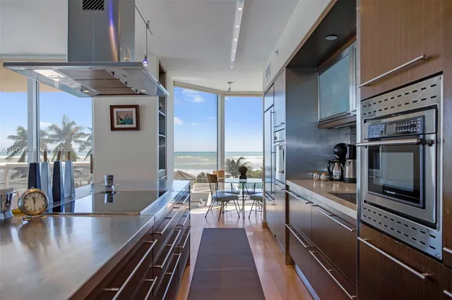a kitchen with stainless steel appliances a stove a sink and cabinets