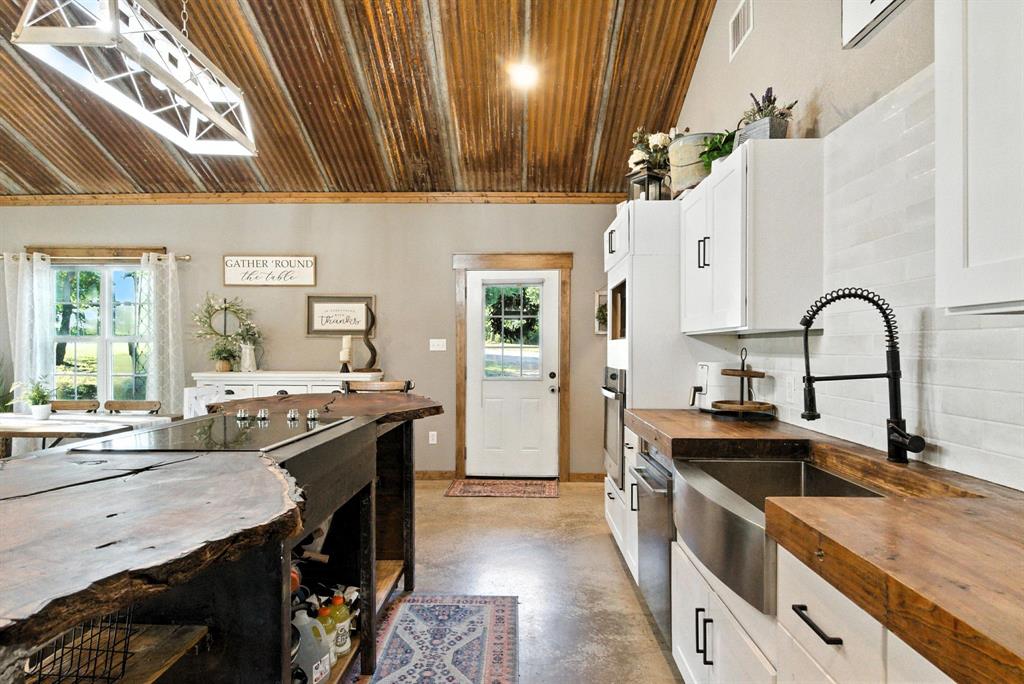 11140 Light Road Lipan, TX 76462 - Photo 17 of 37 a kitchen with a sink stove and cabinets