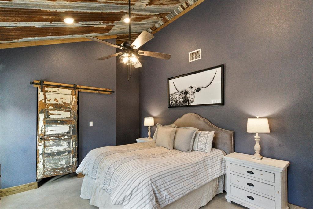 11140 Light Road Lipan, TX 76462 - Photo 19 of 37 a bedroom with a bed and a night stand