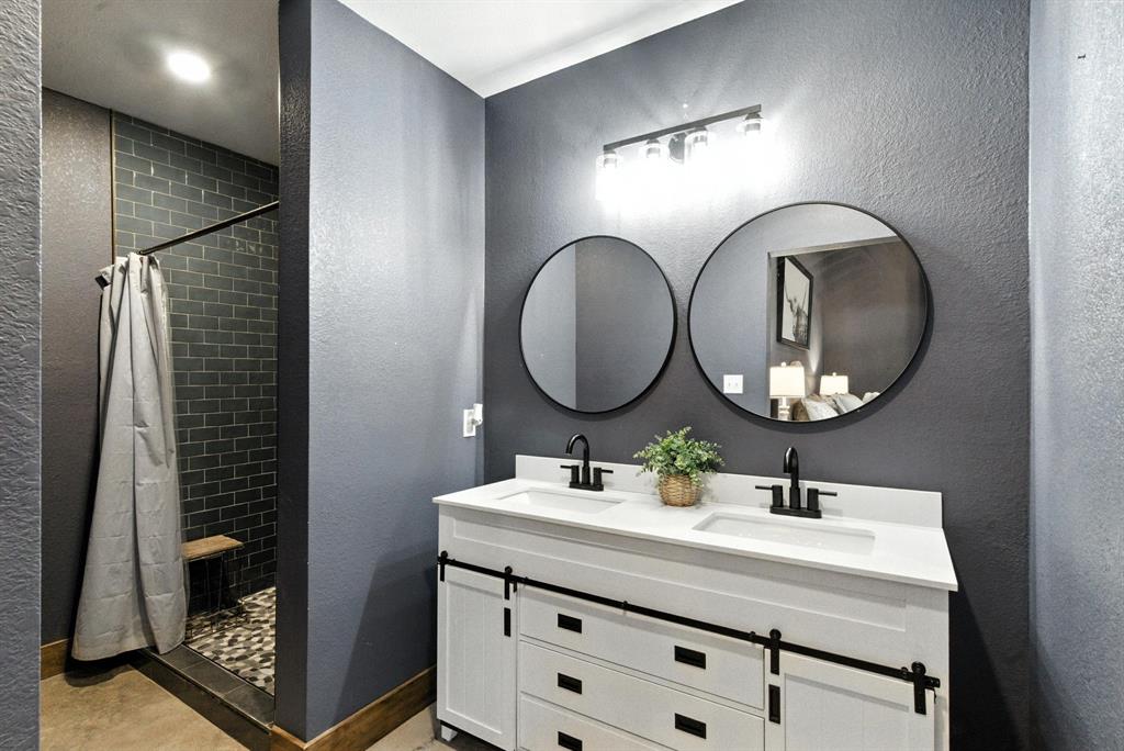 11140 Light Road Lipan, TX 76462 - Photo 20 of 37 a bathroom with a double vanity sink and a mirror