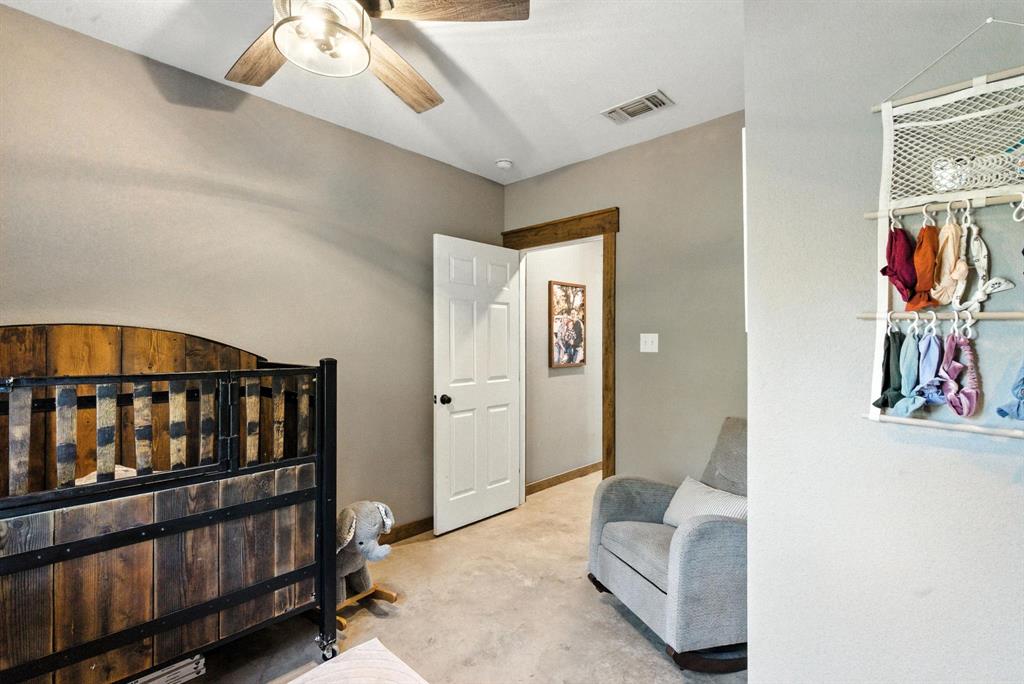 11140 Light Road Lipan, TX 76462 - Photo 22 of 37 a bedroom with furniture and baby crib