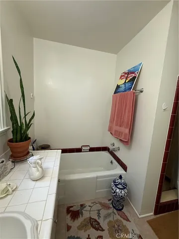 a bathroom with a bathtub and sink