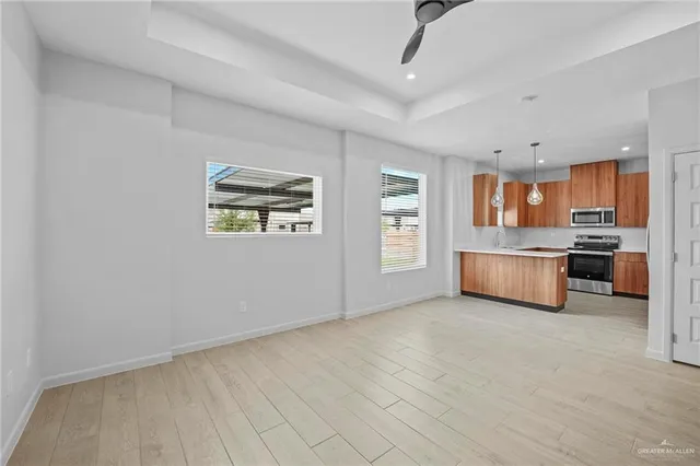 a kitchen with a refrigerator and a stove top oven