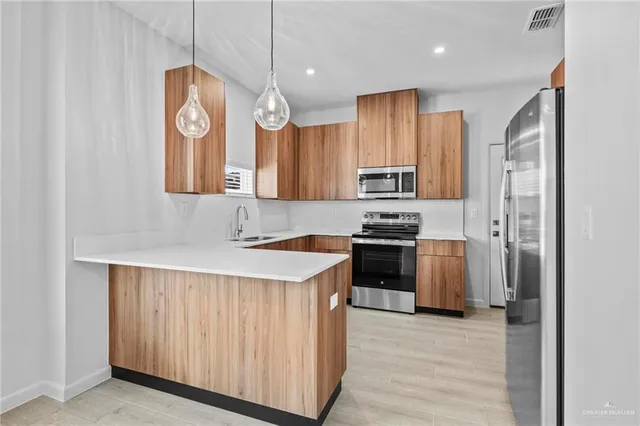 a kitchen with stainless steel appliances a sink cabinets and refrigerator