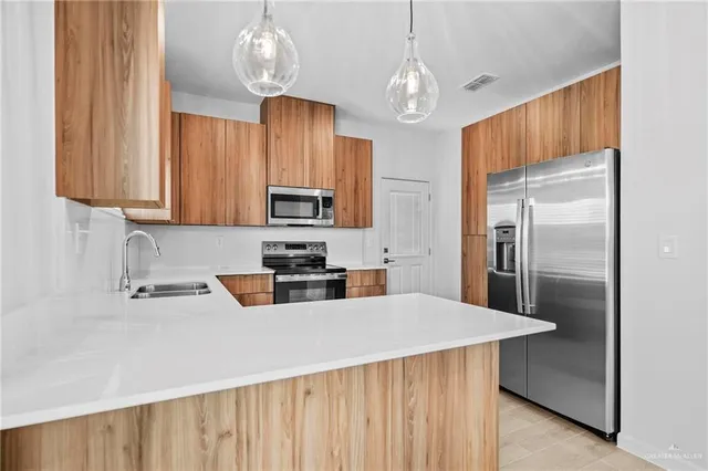 an empty room with ceiling fan and windows