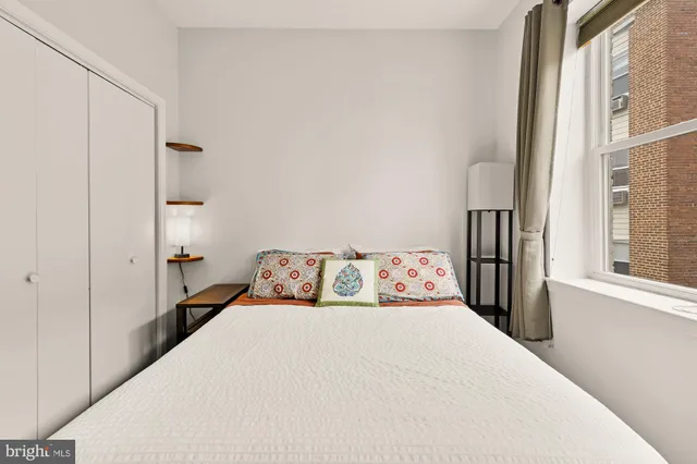 a bedroom with a large bed and a window