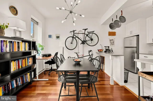 a view of a dining room with furniture and a book shelf