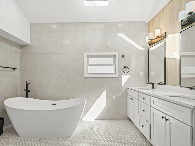 a bathroom with a bathtub and a sink