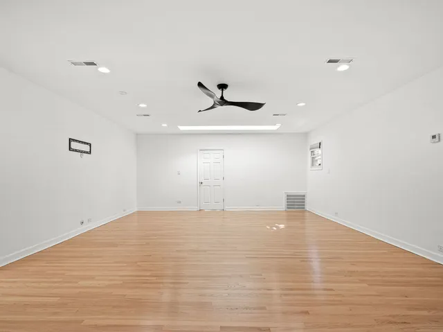 a view of an empty room with a ceiling fan