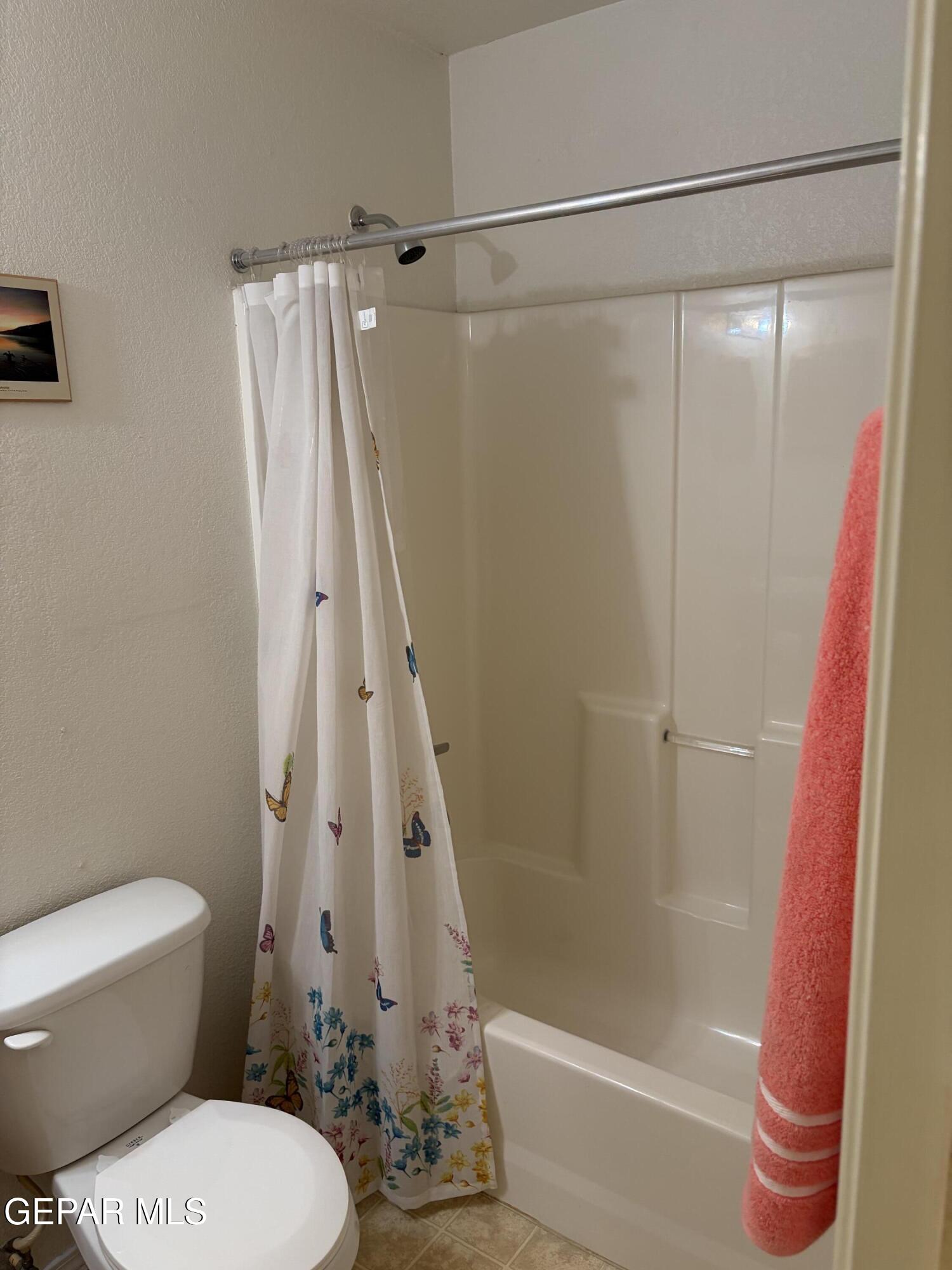 10735 Thunder Road El Paso, TX 79927 - Photo 12 of 32 a bathroom with a shower and a toilet