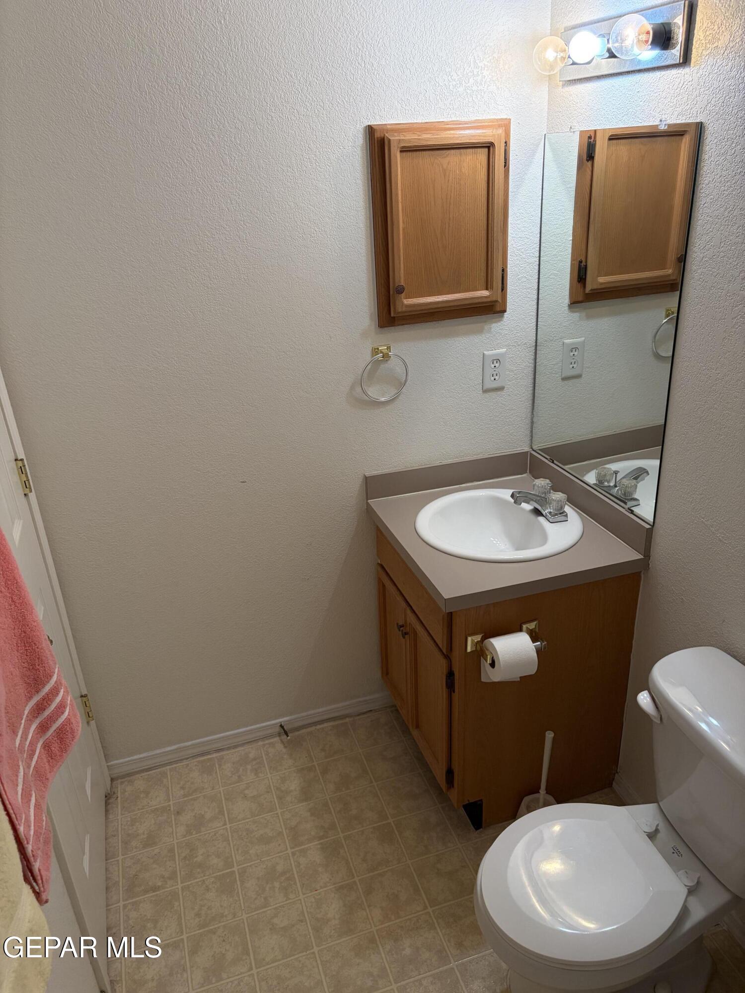10735 Thunder Road El Paso, TX 79927 - Photo 13 of 32 a bathroom with a toilet sink and mirror
