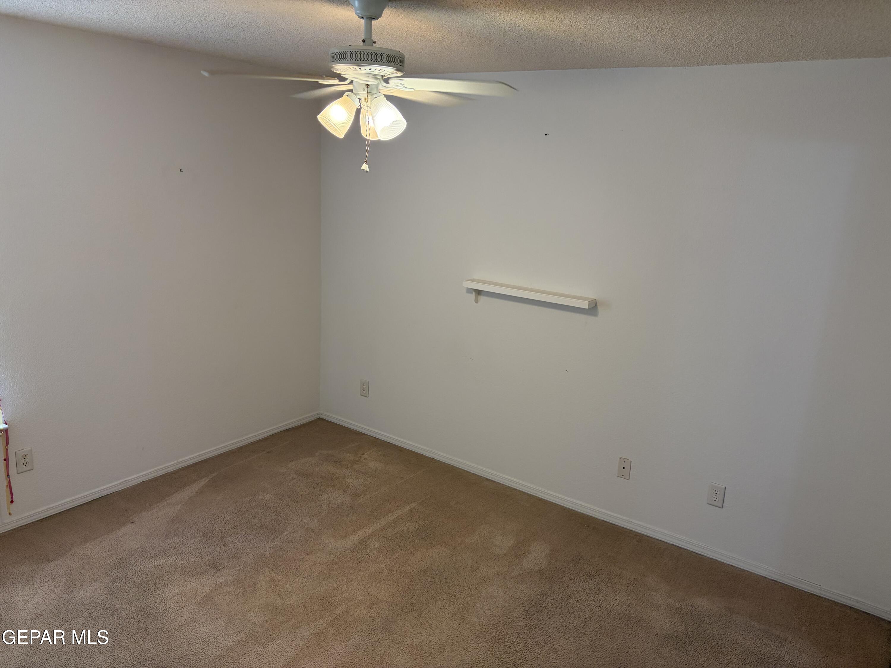 10735 Thunder Road El Paso, TX 79927 - Photo 19 of 32 an empty room with a chandelier fan