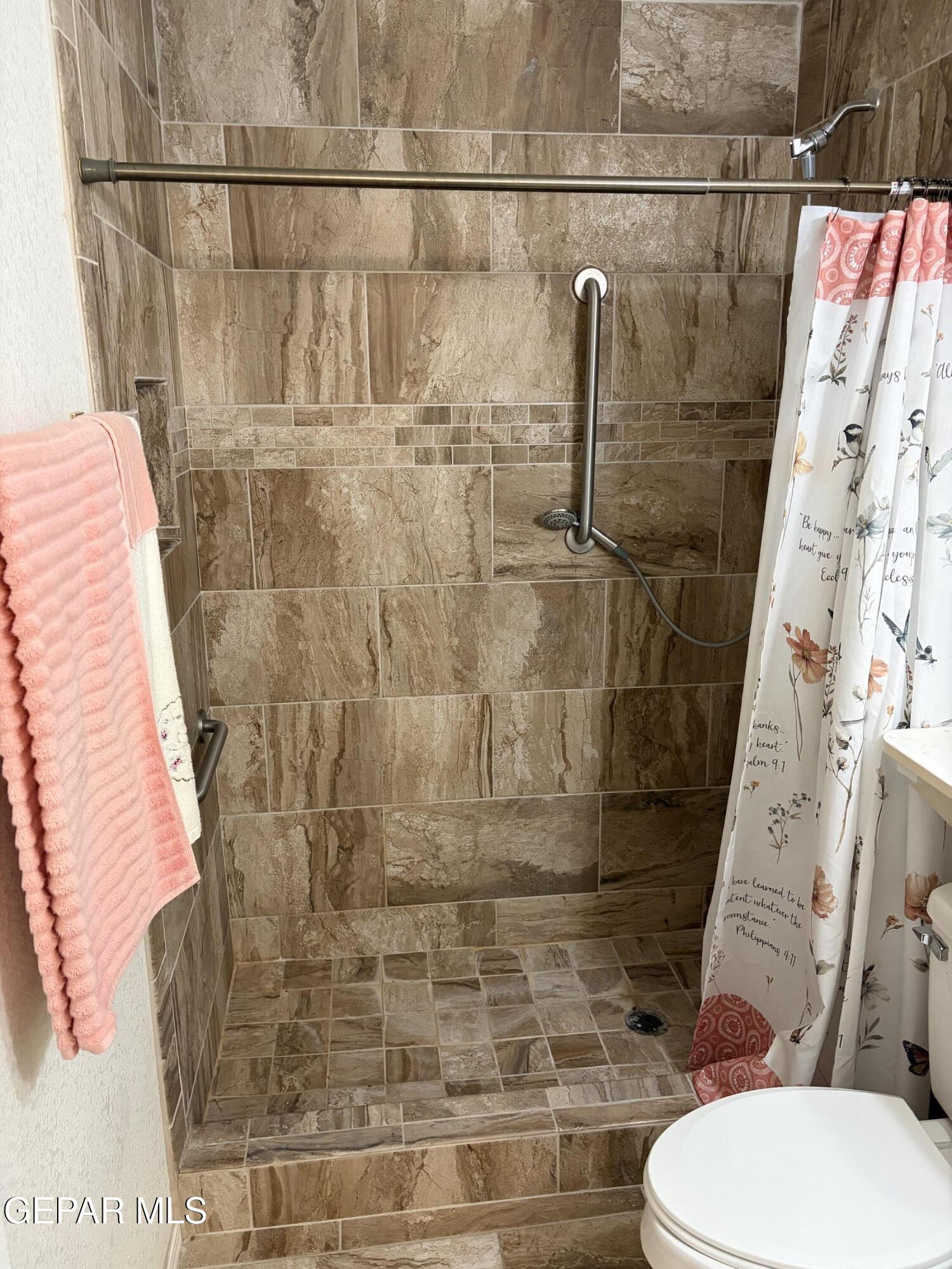10735 Thunder Road El Paso, TX 79927 - Photo 25 of 32 a bathroom with a toilet and shower