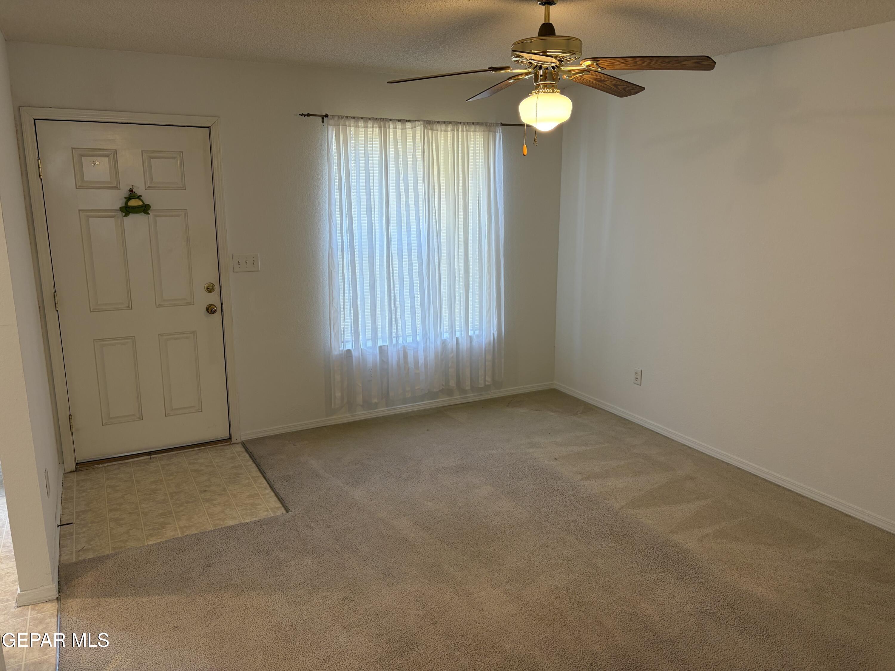 10735 Thunder Road El Paso, TX 79927 - Photo 3 of 32 an empty room with windows and fan