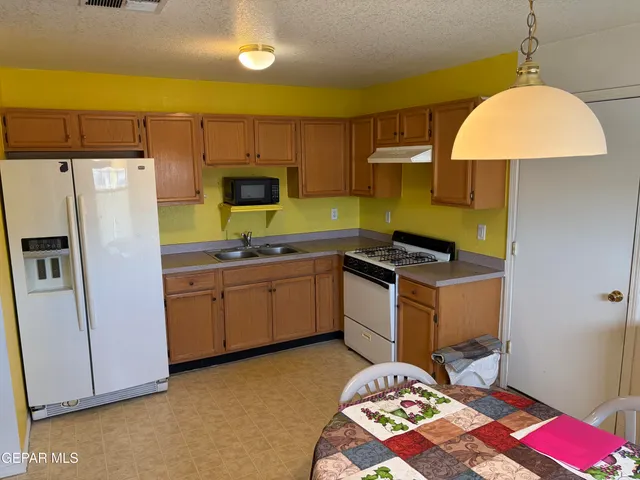 a kitchen with a sink stove and refrigerator