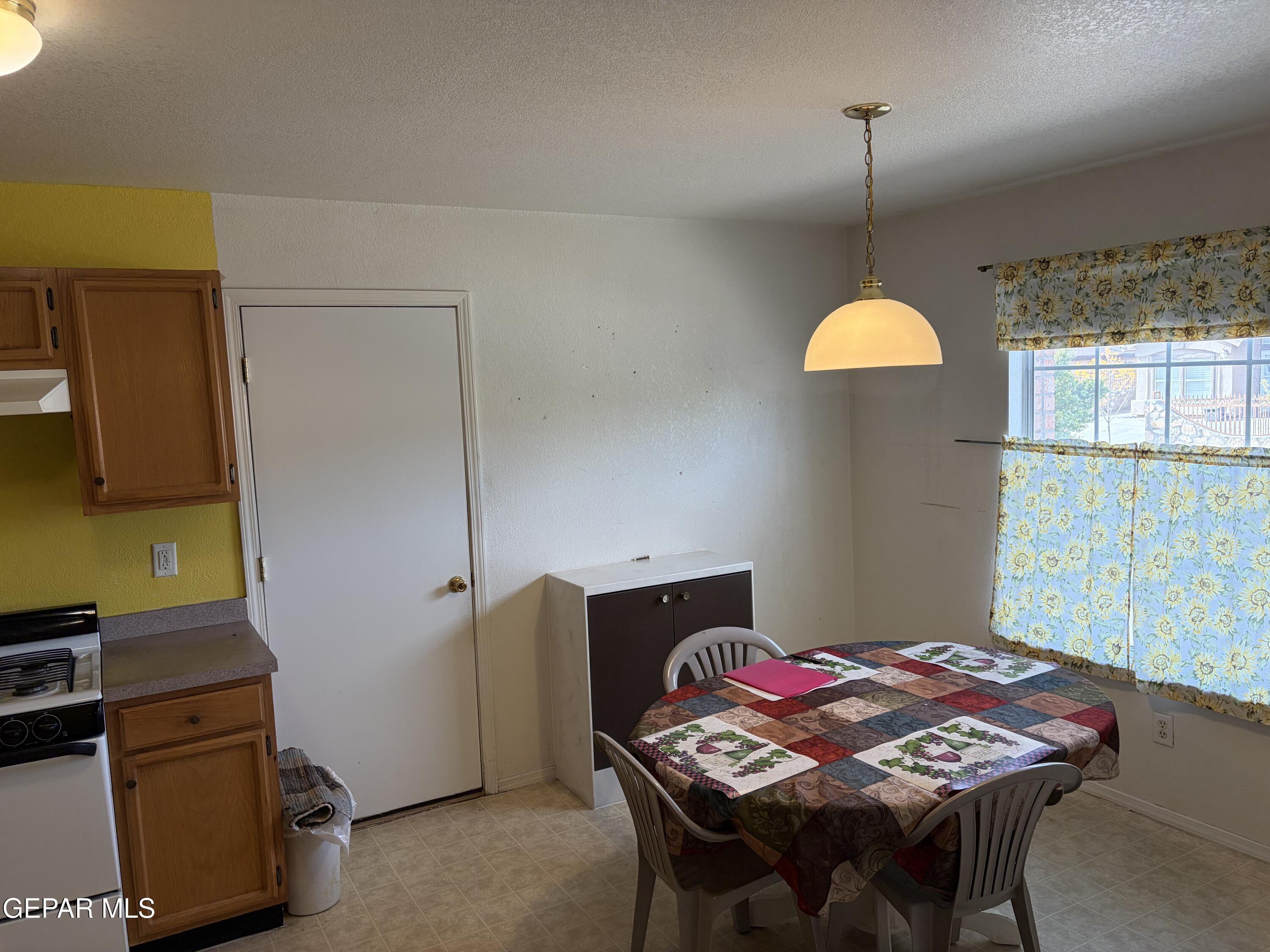 10735 Thunder Road El Paso, TX 79927 - Photo 6 of 32 a bedroom with a bed and a chandelier