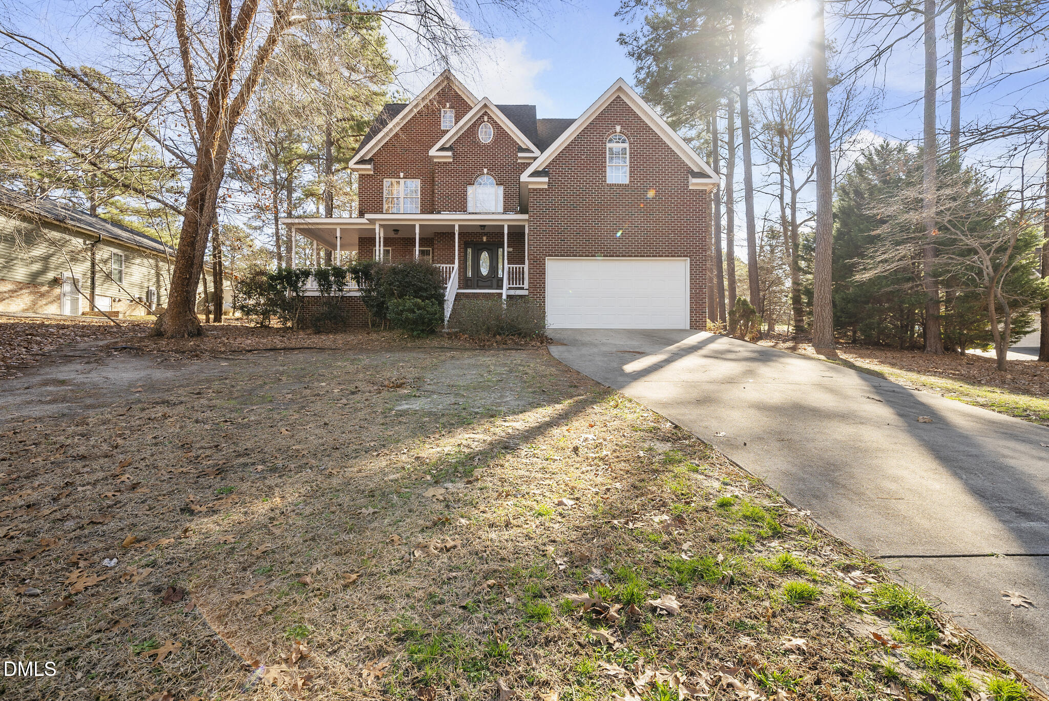 5833 Mockingbird Lane Sanford, NC 27332 - Photo 1 of 34 a front view of a house with a yard and garage