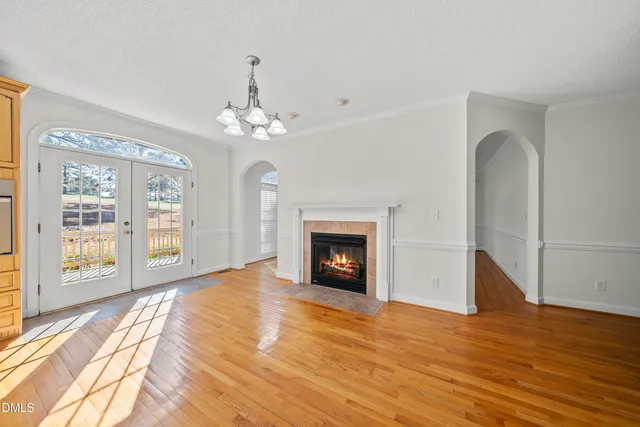 a view of an empty room with window and fire place