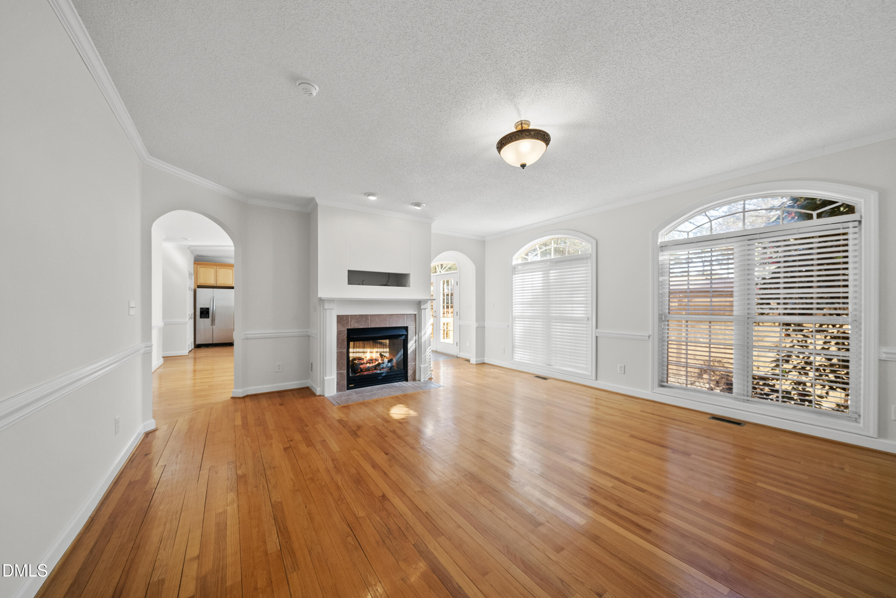 5833 Mockingbird Lane Sanford, NC 27332 - Photo 19 of 34 a view of an empty room with a fireplace and a window