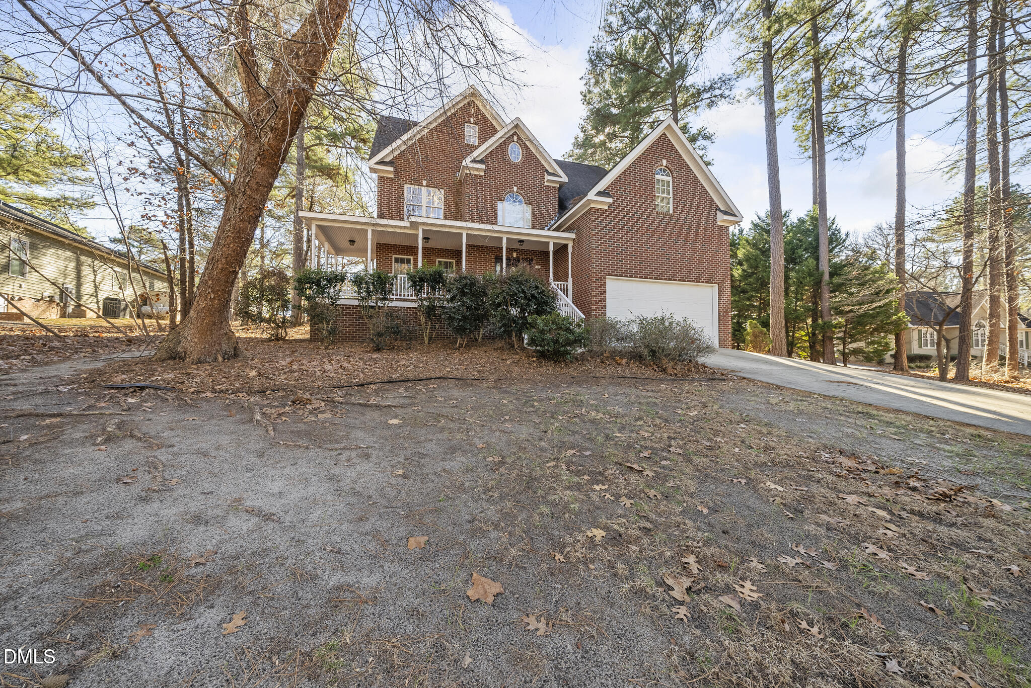 5833 Mockingbird Lane Sanford, NC 27332 - Photo 2 of 34 a front view of a house with a yard and large tree