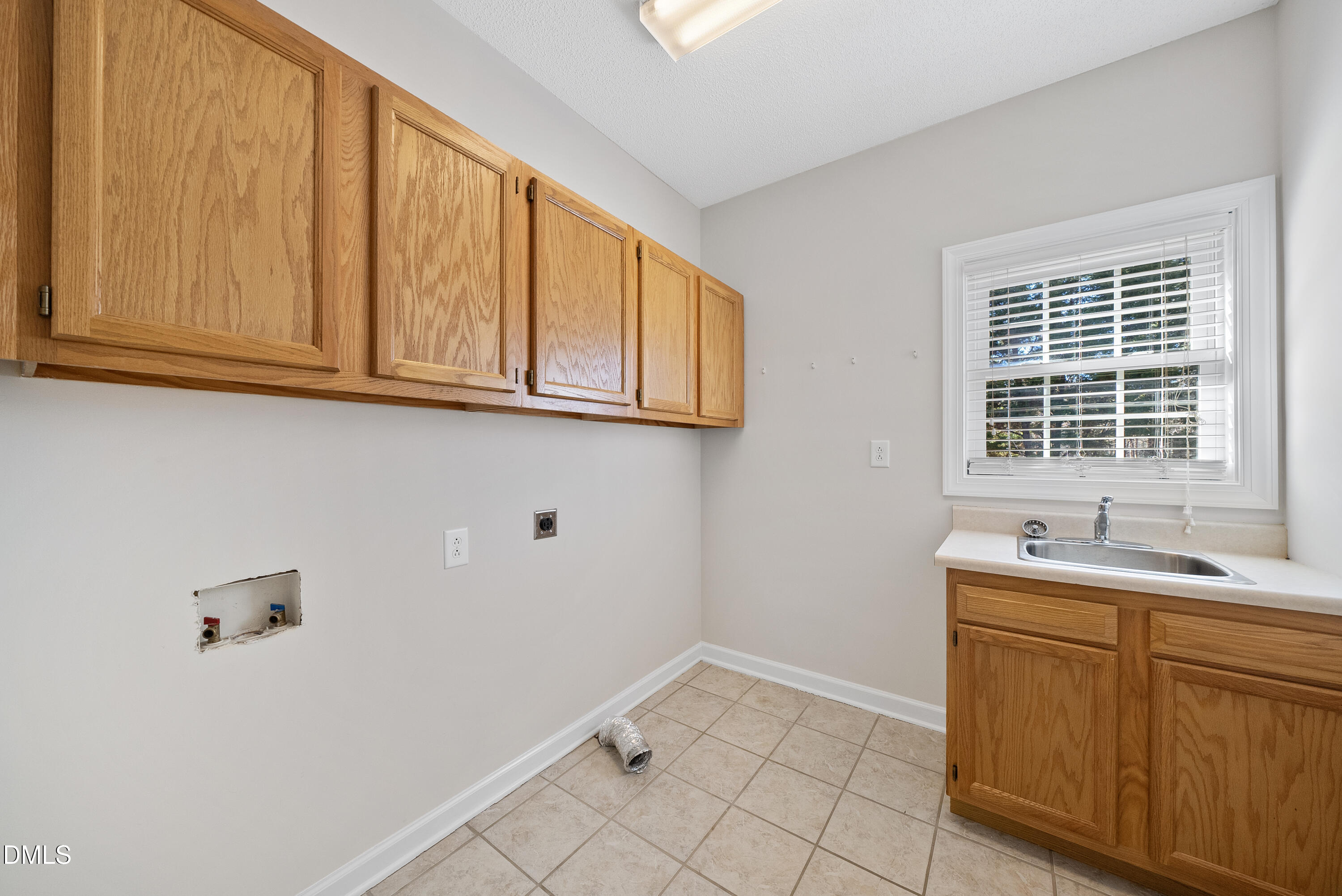 5833 Mockingbird Lane Sanford, NC 27332 - Photo 22 of 34 a room with a sink cabinets and utility