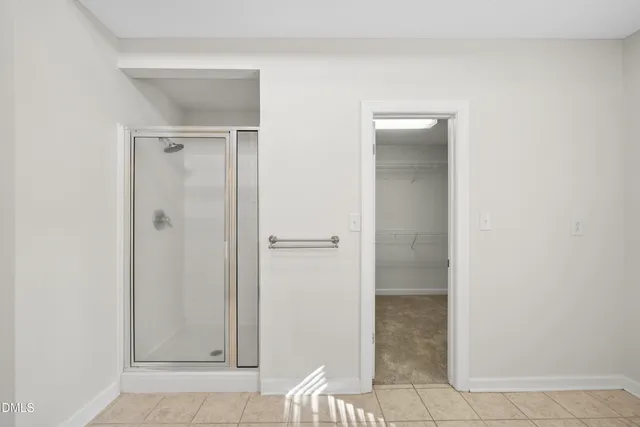 a spacious bathroom with a double vanity sink a mirror a bathtub and