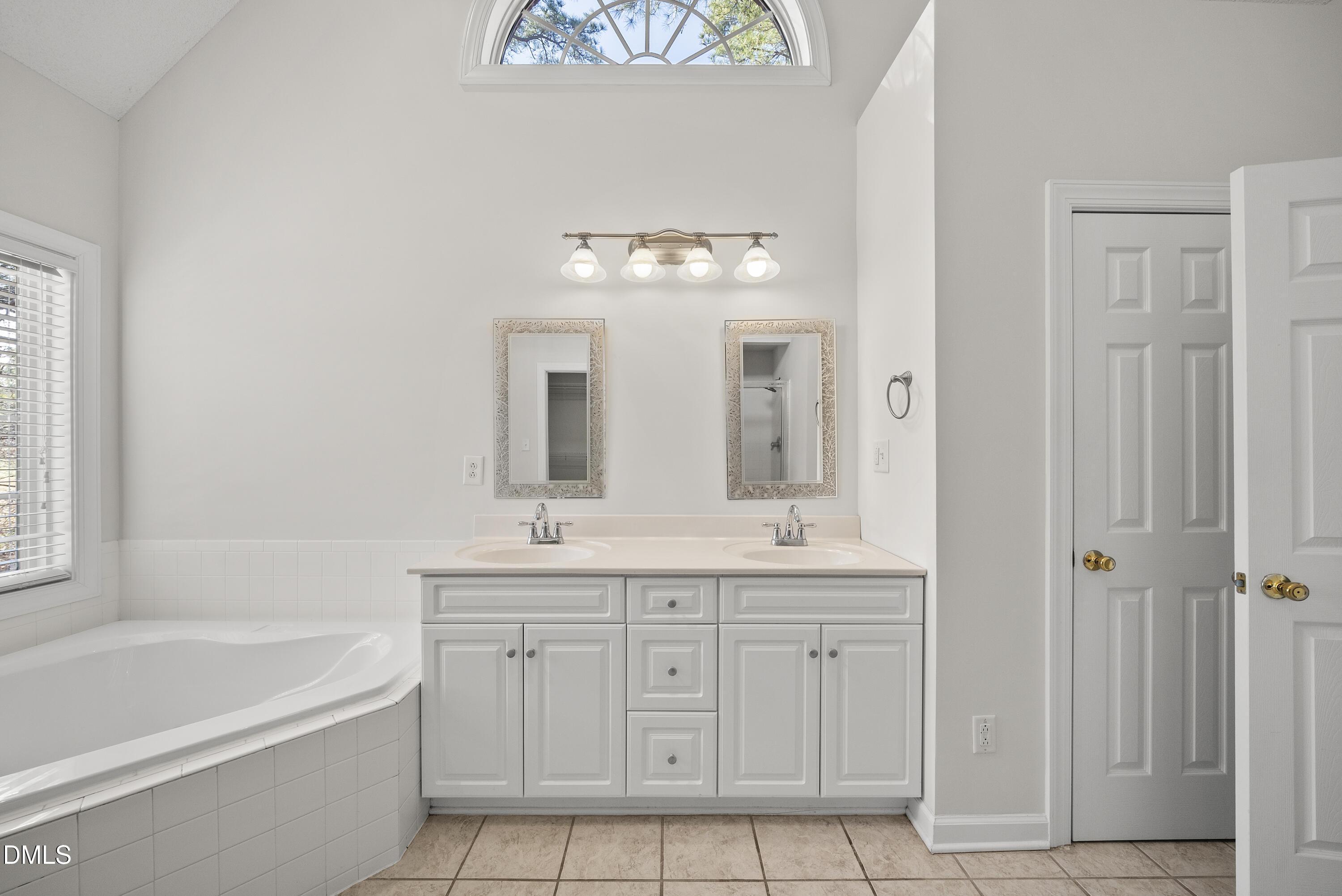 5833 Mockingbird Lane Sanford, NC 27332 - Photo 27 of 34 a spacious bathroom with a double vanity sink a mirror a bathtub and