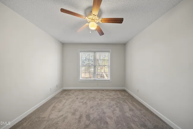 a view of room with a ceiling fan and window