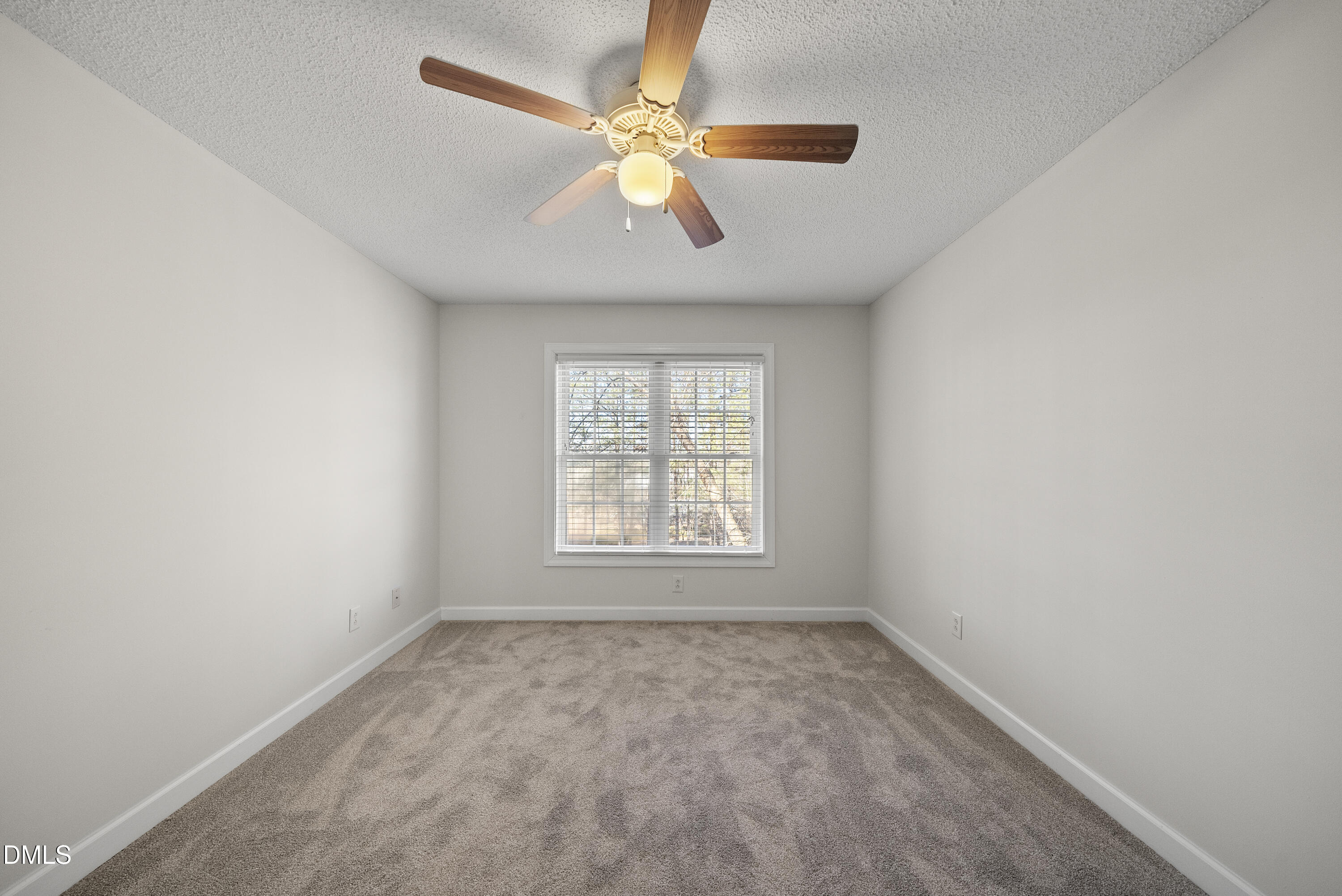 5833 Mockingbird Lane Sanford, NC 27332 - Photo 28 of 34 an empty room with a window and a fan