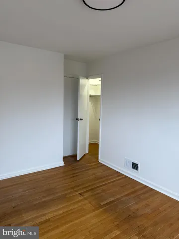 a view of an empty room and wooden floor