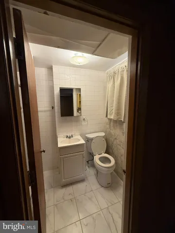a view of empty room with wooden floor and fireplace