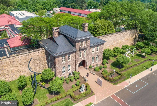 an aerial view of a house with garden space and street view