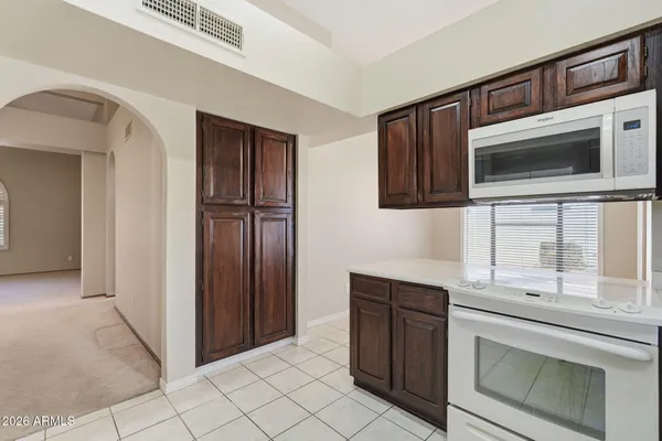 a kitchen with a sink cabinets and window